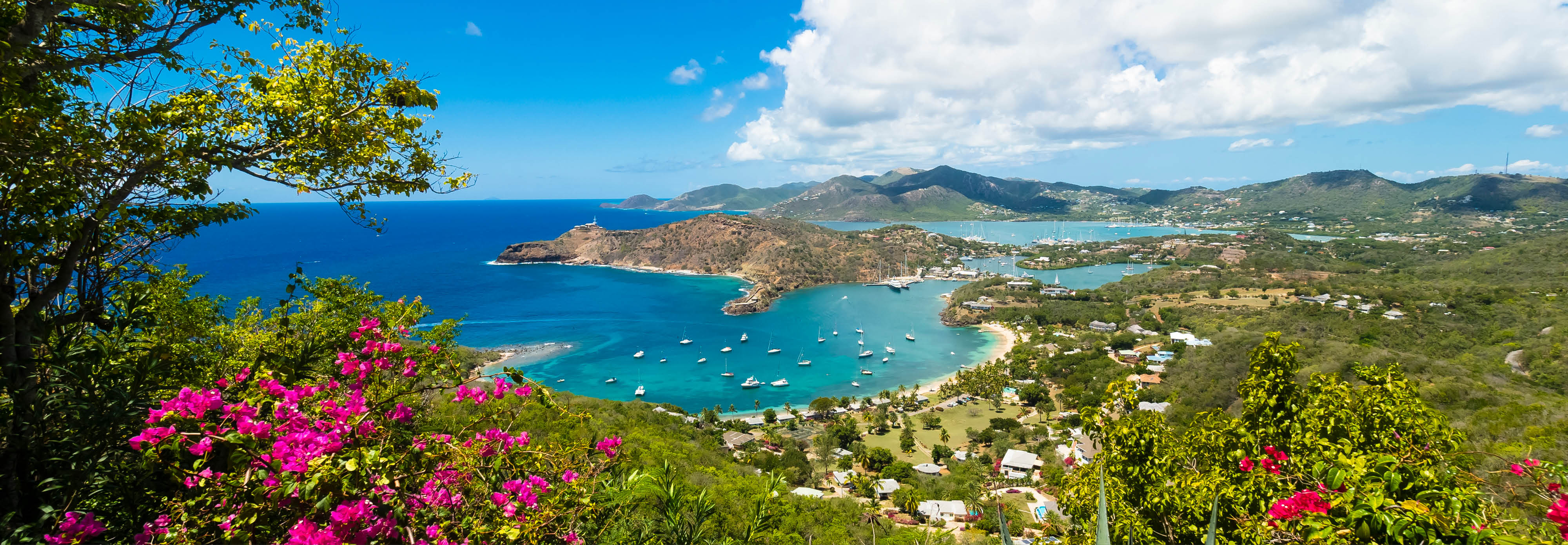 Aerial view of Antigua's turquoise coastline and lush mountains