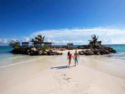 Couple taking a stroll on the beach during the day