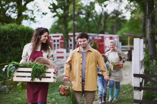 Farm-to-table culinary travel experience with travelers harvesting vegetables on a foodie vacation