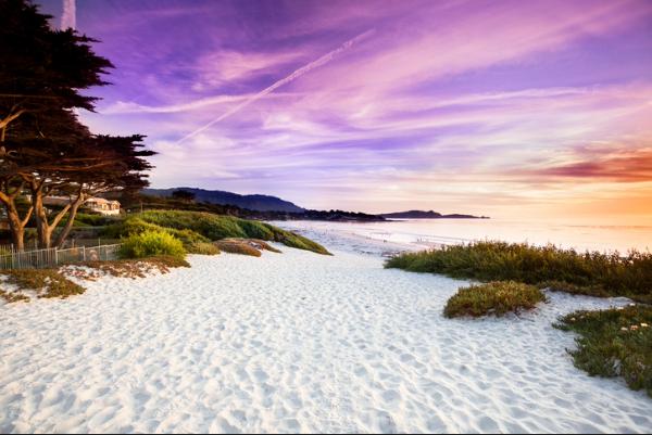 Peaceful sandy beach at sunset with vivid sky and ocean waves