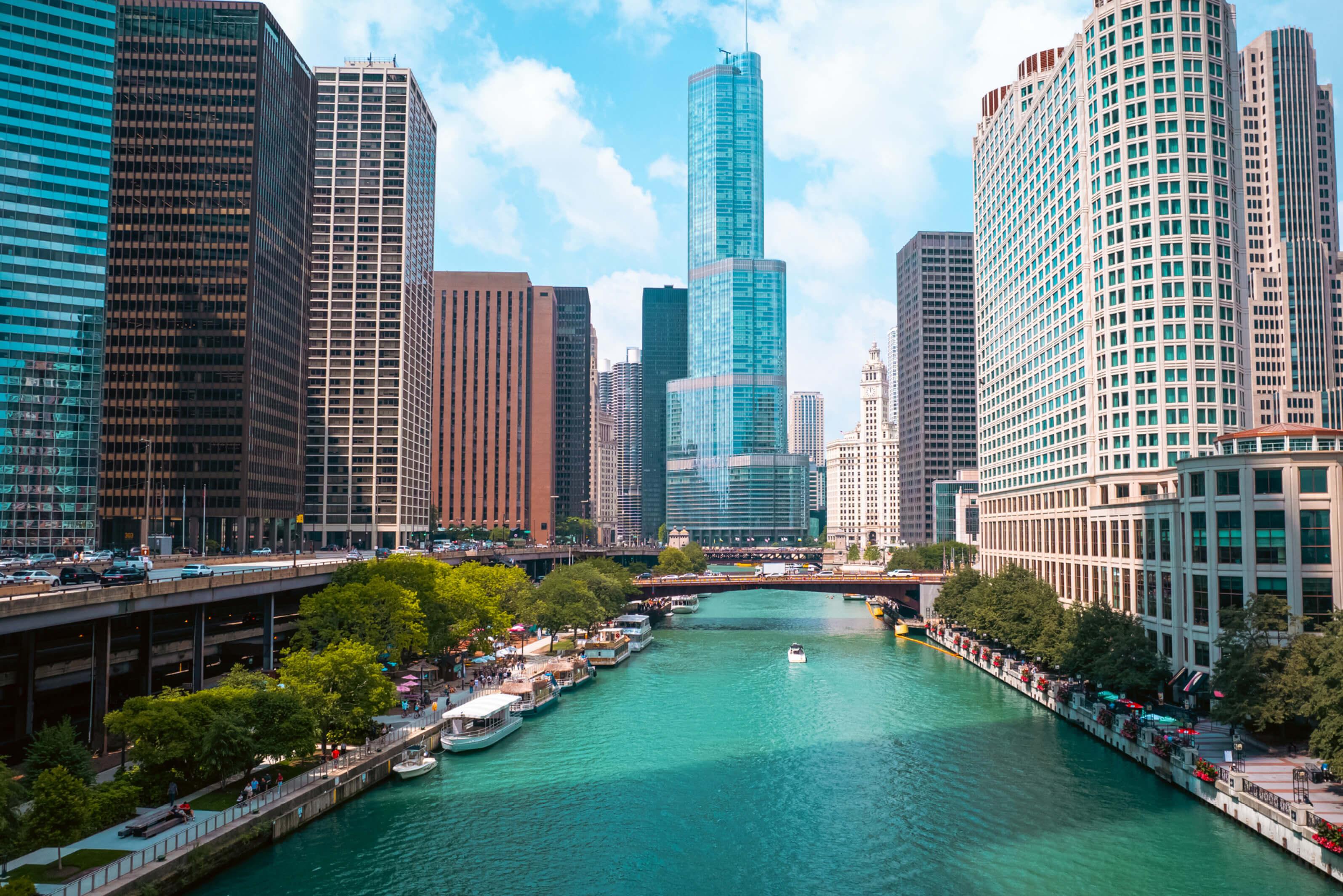 Chicago River flows through the cityscape, with a bridge arching over the water