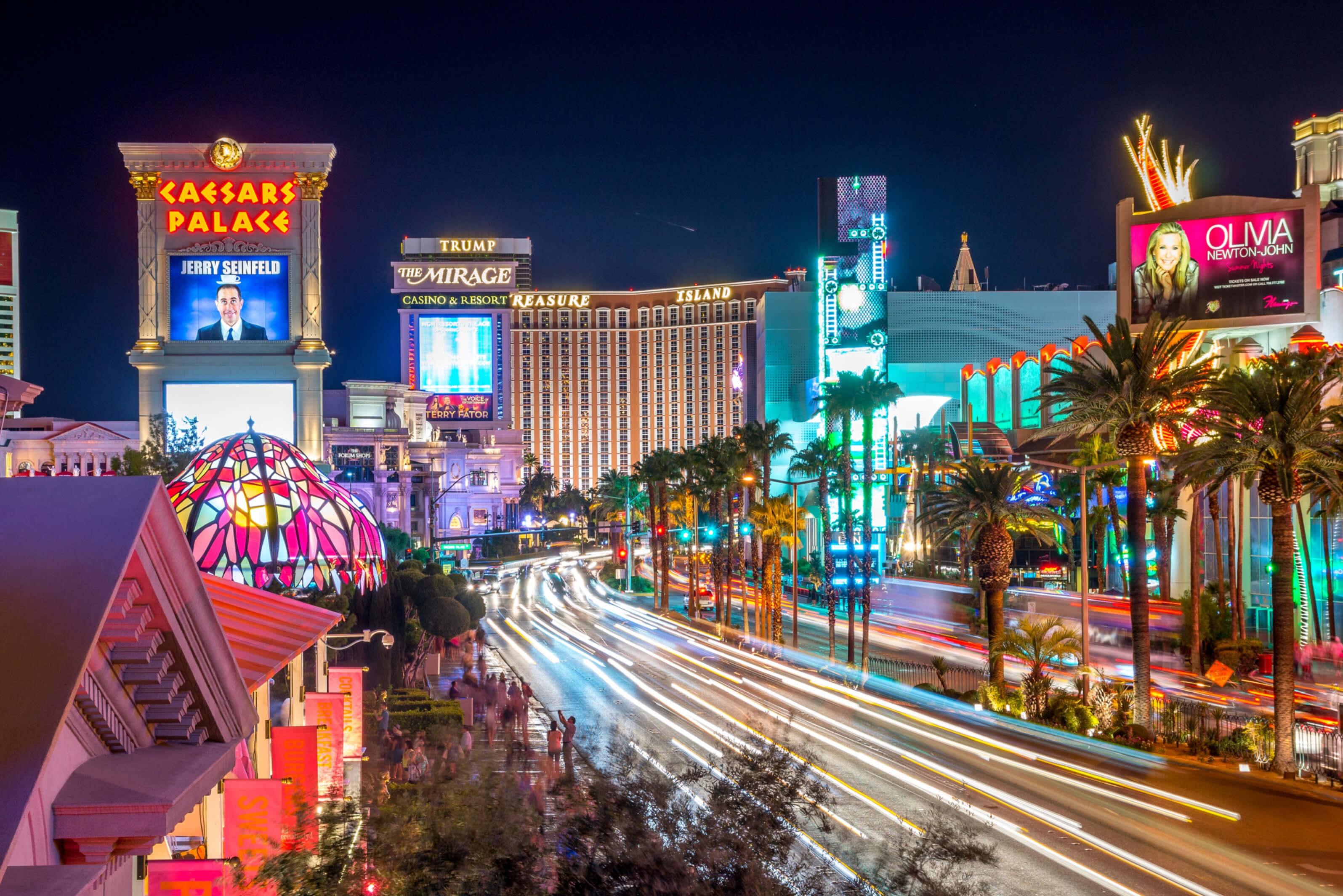 Dynamic downtown Las Vegas Strip, adorned with colorful neon lights and active traffic, capturing the energy of the Nevada city