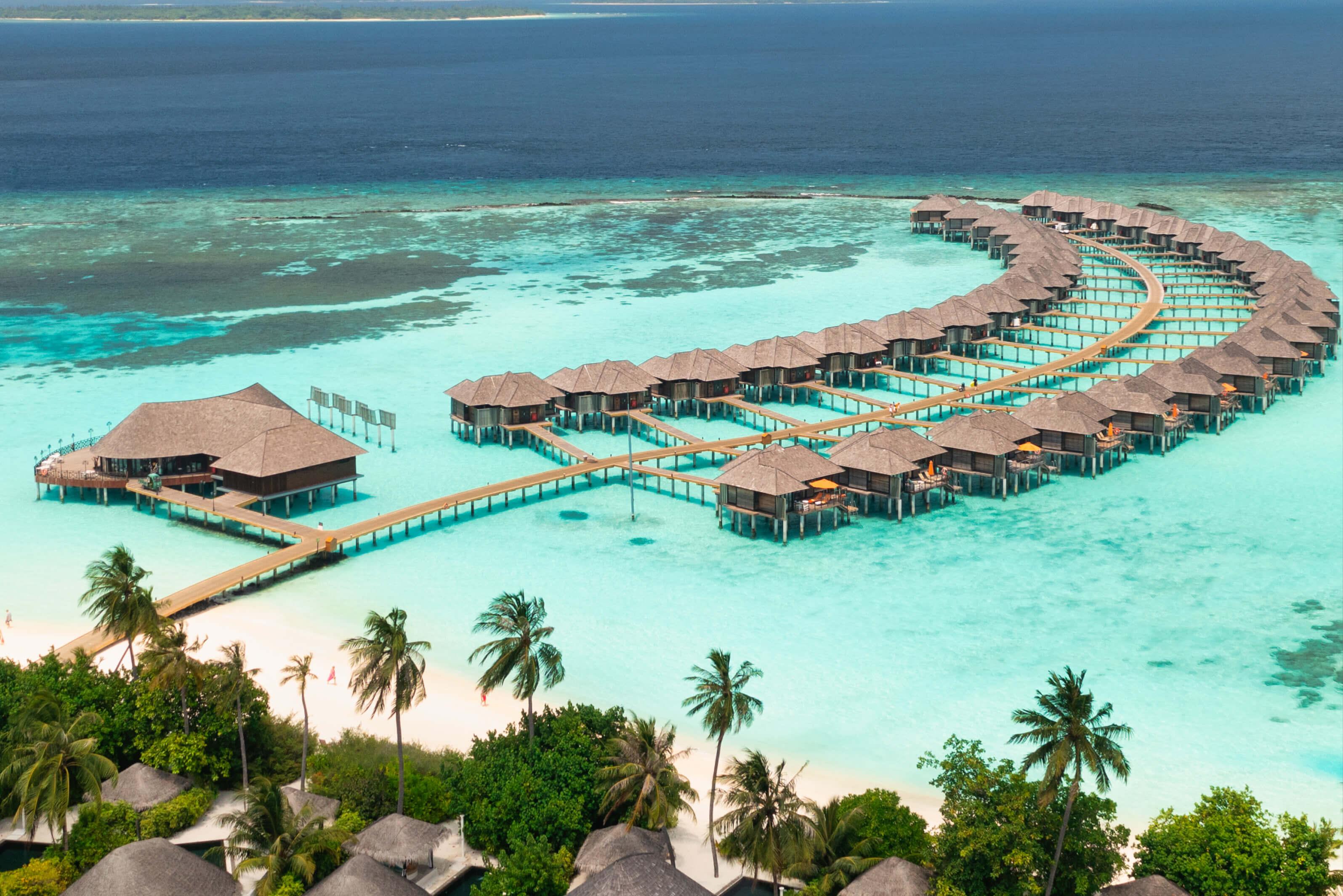 Maldives resort featuring overwater bungalows and vibrant azure ocean