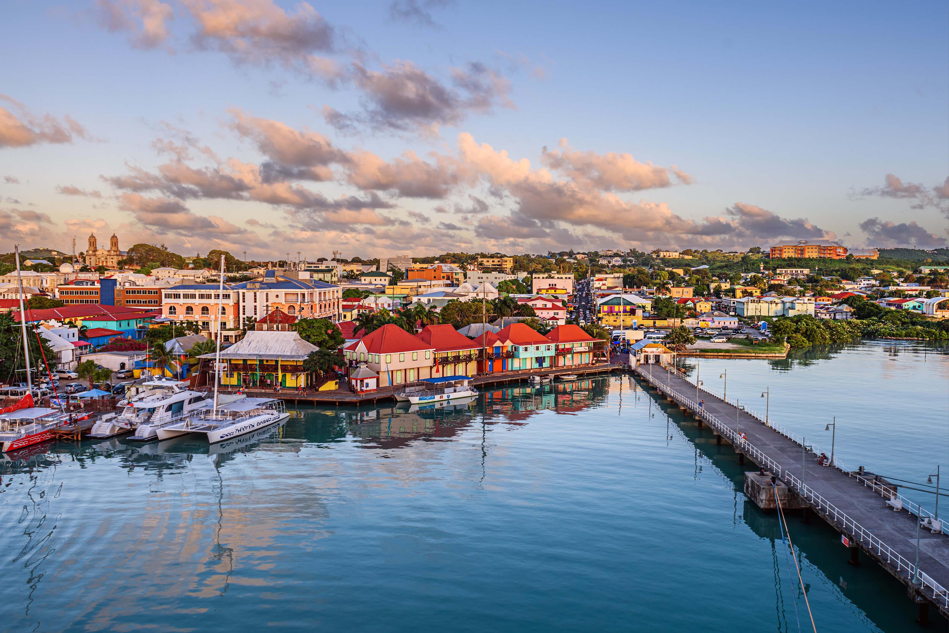 Coastal, colorful village on St. John with docked boats and long bridge