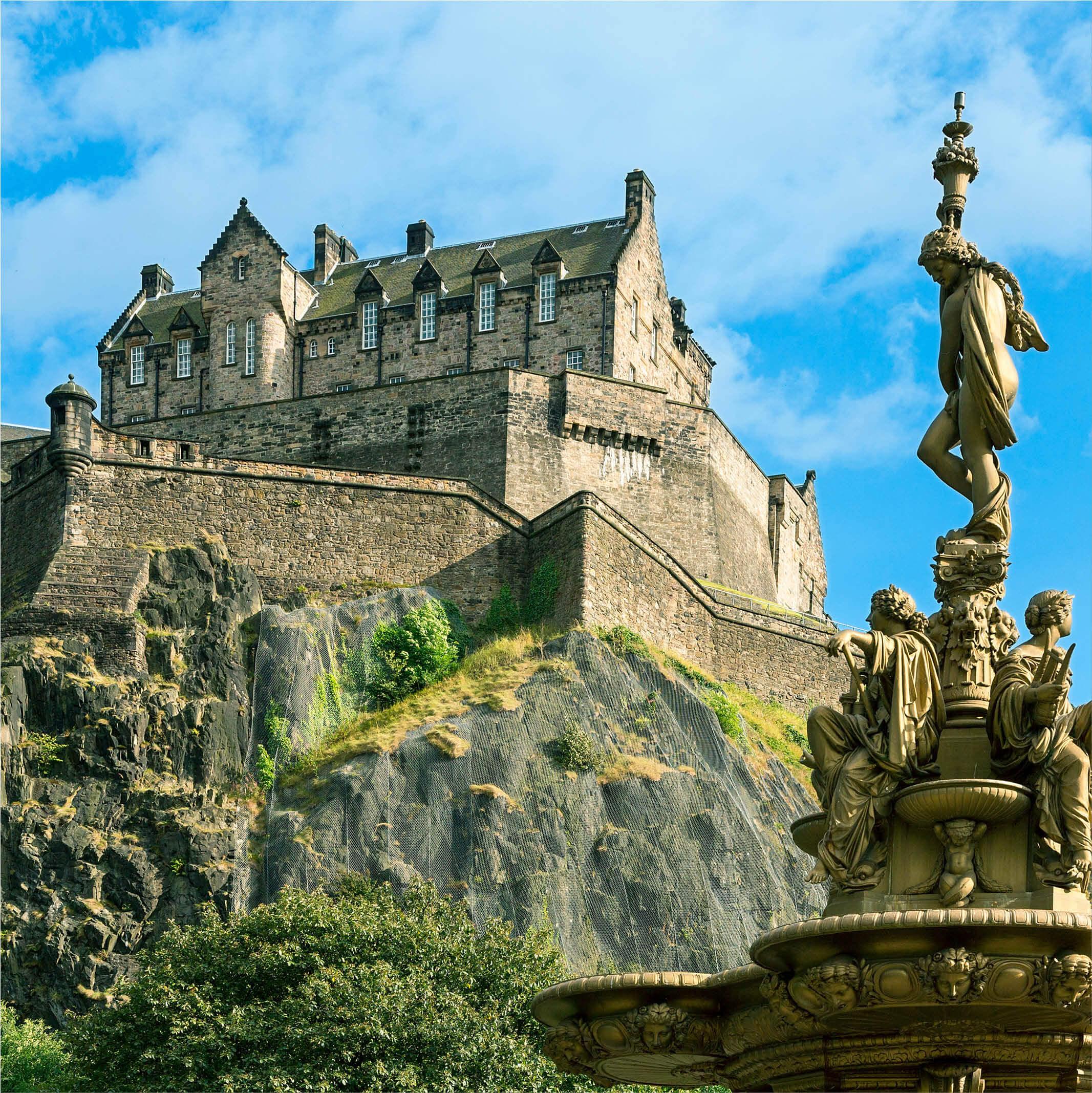 Edinburgh Castle perched on Castle Rock with a statue from the Ross Fountain in the foreground